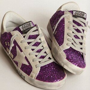 Golden Goose Super-Star sneakers with purple glitter and lettering on the foxing